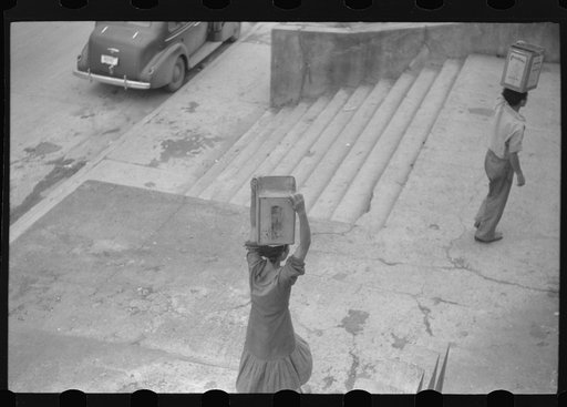 Untitled photo, possibly related to: San Juan, Puerto Rico. People carrying water home because of the failure of the water system in San Juan for three days