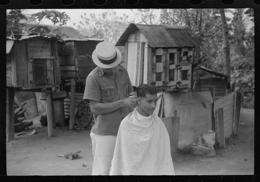 Untitled photo, possibly related to: Yabucoa, Puerto Rico. Striker getting a haircut in the mill village near the sugar mill