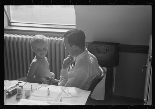 Doctor examining child at preschool clinic. Greenbelt, Maryland