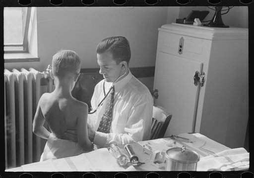 Doctor examining child at preschool clinic. Greenbelt, Maryland