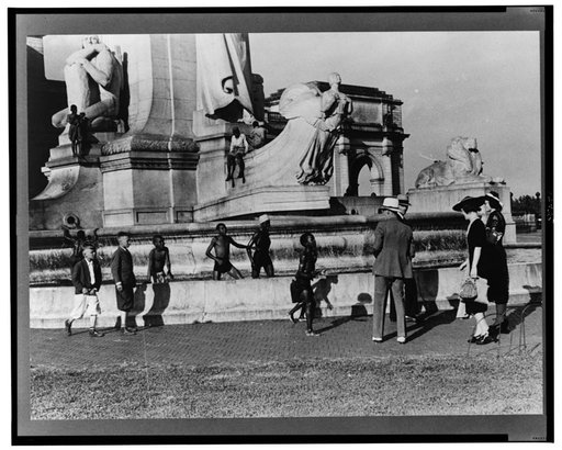 Tourists arriving at Washington, D.C. Throwing pennies to colored boys in fountain across from Union Station