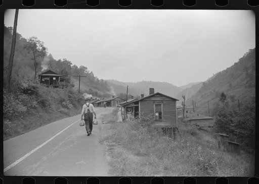 Carrying water to one of the houses in abandoned mining community, Marine, West Virginia