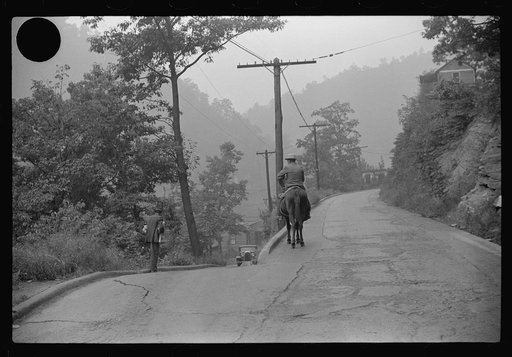 Untitled photo, possibly related to: Old miner on donkey, still quite a common means of transportation, in county road near Mohegan, West Virginia