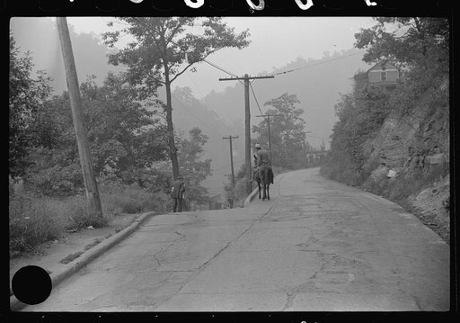 Untitled photo, possibly related to: Old miner on donkey, still quite a common means of transportation, in county road near Mohegan, West Virginia