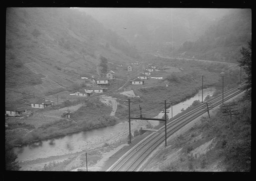 Untitled photo, possibly related to: Houses in abandoned mining town with remains of coal tipple at right, Mohegan, West Virginia