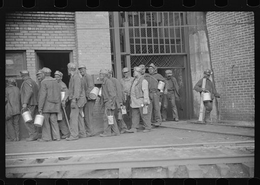 Miners turning in lamps after getting out of cage from shaft, which goes down sixty feet to tunnel, which is two miles long. Caples, West Virginia