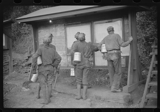 Untitled photo, possibly related to: Miners looking at daily reports, checking the number of tons of slate and coal they loaded during their shift. Also to find out whether or not they work the next day. Caples, West Virginia