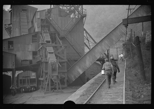 Untitled photo, possibly related to: Miners starting home after work. Part of coal tipple shown at left. West Virginia