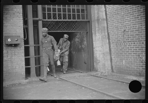 Untitled photo, possibly related to: Miners turning in lamps and starting home. Caples, West Virginia