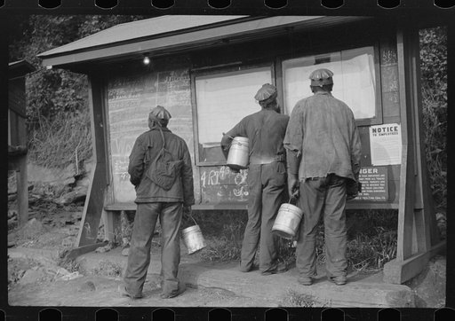 Miners looking at daily reports, checking the number of tons of slate and coal they loaded during their shift. Also to find out whether or not they work the next day. Caples, West Virginia