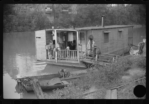 Untitled photo, possibly related to: Child on back porch of his home, riverboat house in Charleston, West Virginia
