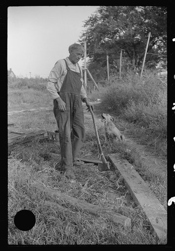 Untitled photo, possibly related to: Man, who lives on houseboat in river chopping wood for stove. Charleston, West Virginia