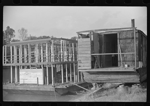 At left, unfinished pleasure boat for dancing, etc., and at right rear of houseboat moved up on bank for family to live in, Charleston, West Virginia