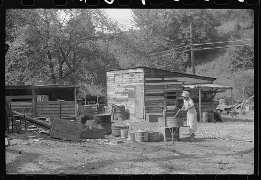 WPA (Works Progress Administration) worker's wife washing clothes in front yard. South Charleston, West Virginia