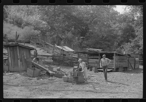 WPA (Works Progress Administration) worker's wife washing clothes in front yard. South Charleston, West Virginia