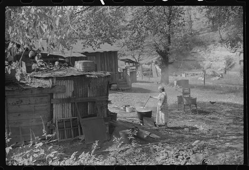 Old and sick, mine foreman's wife does washings in front yard. South Charleston, West Virginia