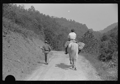 Untitled photo, possibly related to: Miner and wife taking home provisions bought at company store, Caples, West Virginia