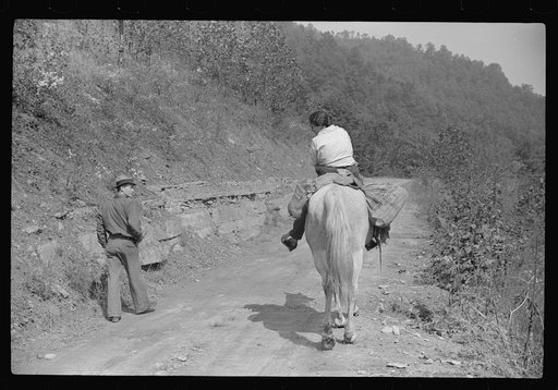 Untitled photo, possibly related to: Miner and wife taking home provisions bought at company store, Caples, West Virginia