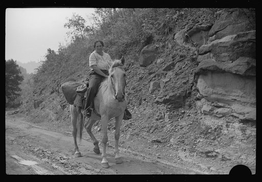 Untitled photo, possibly related to: Coal miner's wife bringing groceries from company store, Caples, West Virginia