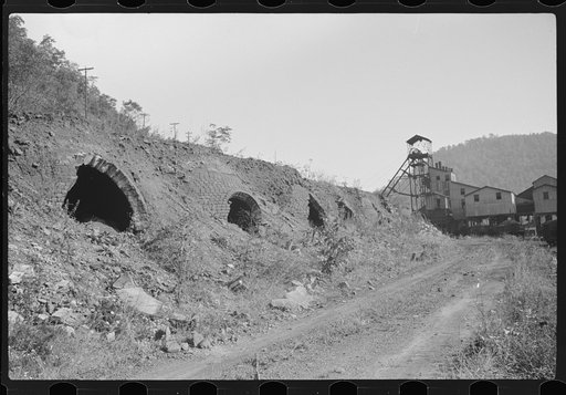 Old abandoned coke ovens with mine tipple in background, Maitland, West Virginia