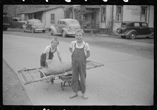 Children taking home remains of a bed. Coal mining camp, Scotts Run, West Virginia