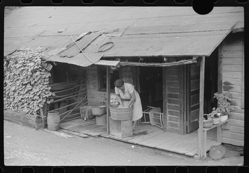 Untitled photo, possibly related to: Coal miner's wife washing clothes on front porch, Chaplin, West Virginia
