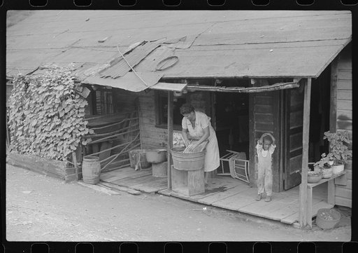 Coal miner's wife washing clothes on front porch, Chaplin, West Virginia