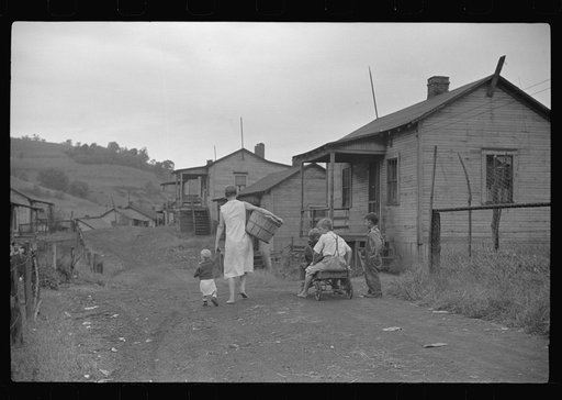 Untitled photo, possibly related to: Coal miner's wife and child on main road in community.  Chaplin, West Virginia