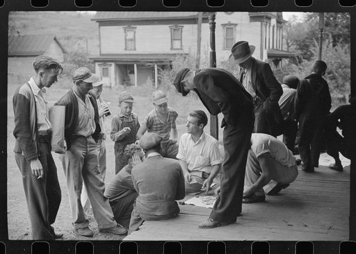 Coal miners card gambling Saturday afternoon on porch of company store, Chaplin, West Virginia