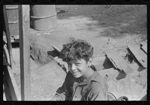 Mexican miner's child, doesn't go to school much. He's too shy and school's too far away, especially when it is cold. Bertha Hill, West Virginia