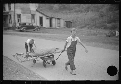 Untitled photo, possibly related to: Children taking home remains of a bed. Coal mining camp, Scotts Run, West Virginia