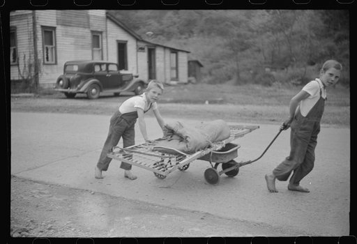 Untitled photo, possibly related to: Children taking home remains of a bed. Coal mining camp, Scotts Run, West Virginia