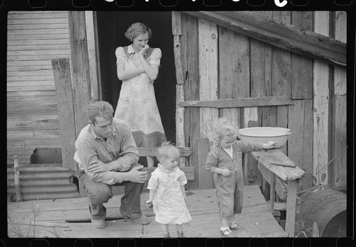 Untitled photo, possibly related to: Coal miner and two of his children on their back porch. Bertha Hill, West Virginia