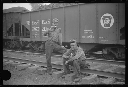 Untitled photo, possibly related to: Coal miners waiting for the bus, eating ice cream suckers (popsicles). Pursglove, West Virginia
