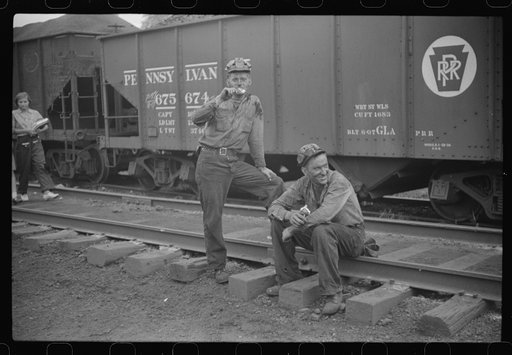 Untitled photo, possibly related to: Coal miners waiting for the bus, eating ice cream suckers (popsicles). Pursglove, West Virginia