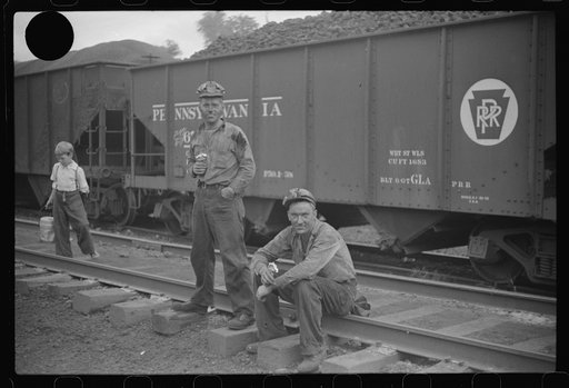 Untitled photo, possibly related to: Coal miners waiting for the bus, eating ice cream suckers (popsicles). Pursglove, West Virginia