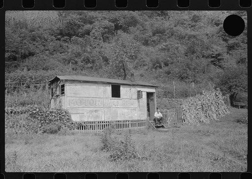 Untitled photo, possibly related to: Unemployed miner's home he built. "It'll be purtier when I paint it." Scotts Run, Osage, West Virginia