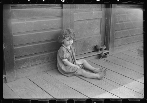 Miner's daughter on front porch, abandoned mining town, Jere, West Virginia
