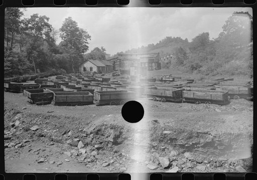Untitled photo, possibly related to: Old coal trucks and tipple in background in abandoned mining town, Jere, West Virginia