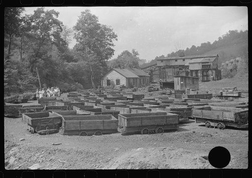 Untitled photo, possibly related to: Old coal trucks and tipple in background in abandoned mining town, Jere, West Virginia