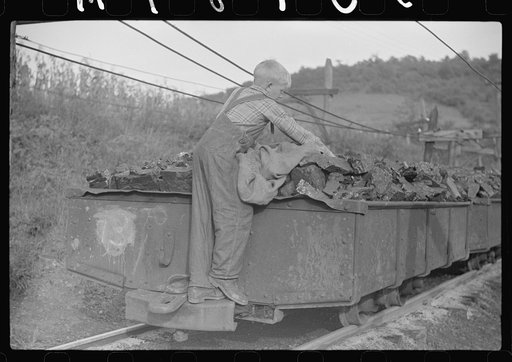 Coal miner's son swiping coal from coal cars for home use. The "Patch," Chaplin, West Virginia
