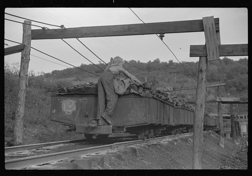 Untitled photo, possibly related to: Coal miner's son swiping coal from coal cars for home use. The "Patch," Chaplin, West Virginia