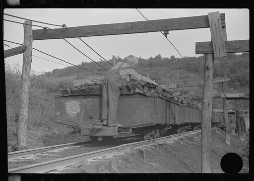 Untitled photo, possibly related to: Coal miner's son swiping coal from coal cars for home use. The "Patch," Chaplin, West Virginia