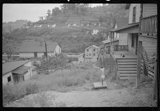 Untitled photo, possibly related to: Coal miner's wife getting water from pump, company houses, Pursglove, Scotts Run, West Virginia