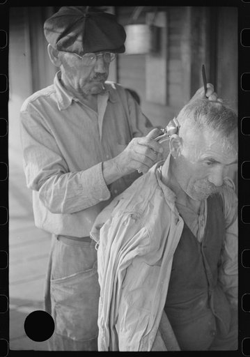 Untitled photo, possibly related to: Miners often give haircuts on front porch. The "Patch," Chaplin, West Virginia