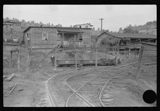 Untitled photo, possibly related to: Coal miners switching motor. Note live wires. The "Patch," Chaplin, West Virginia