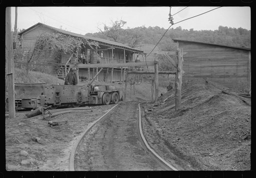 Untitled photo, possibly related to: Coal miners switching motor. Note live wires. The "Patch," Chaplin, West Virginia