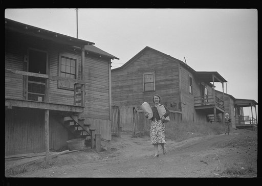 Coal miner's wife bringing home the groceries on payday from company store, Chaplin, West Virginia