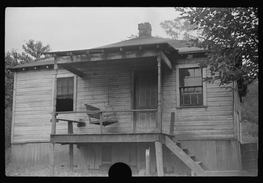 Untitled photo, possibly related to: Coal miner, his wife and two of their children (note child's legs). Bertha Hill, West Virginia