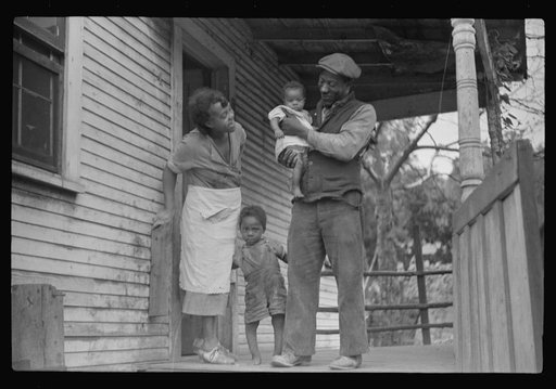 Untitled photo, possibly related to: Coal miner, his wife and two of their children (note child's legs). Bertha Hill, West Virginia